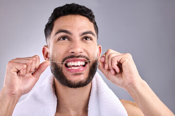 Face, man and floss teeth for dental health in studio isolated on a white background. Tooth,...