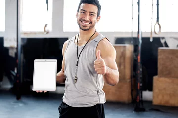 Fototapeten Portrait, thumbs up and man with tablet screen in gym for mockup after exercise. Face, like hand gesture and personal trainer with technology, happy and space for marketing, advertising and fitness. © Vamumusa C/peopleimages.com