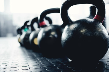 Fitness, weights and kettlebell on floor of gym for workout, strong and exercise. Metal, iron and...