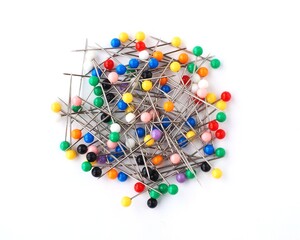 A lot of colorful ball head sewing pins isolated on a white background 