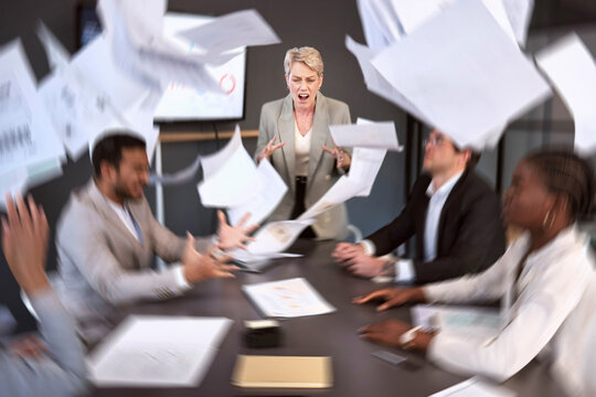 Diversity, woman ceo screaming in anger at colleagues and paperwork in a meeting room at their workplace. Problem, paper and female manager scream at her coworkers with documents falling around