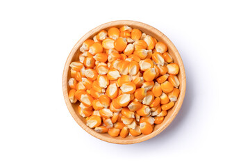 Dry corn seeds (raw popcorn grains) in wooden bowl isolated on white background with clipping path.