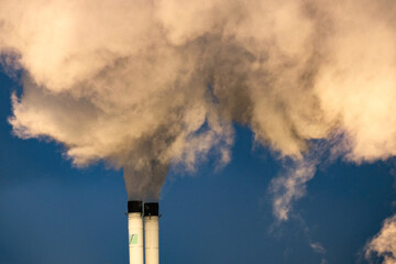 Industrial pollution in the factory, exhaust gas from smoke chimneys. Industrial area, thick plumes of smoke. Global Climate change