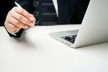 Business performance checklist, Quick checklist and clipboard management concept, job applicants, businessman using laptop doing online checklist survey,Employees must complete the online survey form.