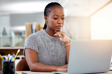 Laptop, research and a business black woman thinking while working at her desk in her office with...