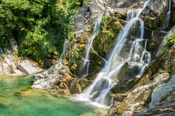 Mountain waterfall on a sunny spring day. Jump of torrente Torre at Crosis waterfall, Tarcento,...