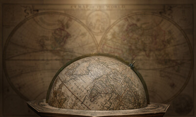 Old geographical globe on map background. Science, education, travel, vintage background. History and geography team. Ancience, antique globe on the background of books.