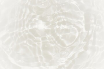 Obraz premium White water with ripples on the surface. Defocus blurred transparent white colored clear calm water surface texture with splashes and bubbles. Water waves with shining pattern texture background.