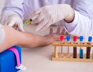 Young handsome man during blood test sampling procedure