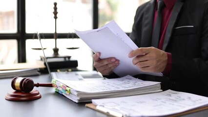 Lawyer working on legal documents in lawyer office. - Powered by Adobe