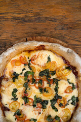 Pizza with mozzarella and provolone cheese, garlic and cherry tomatoes.