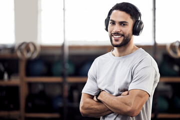 Headphones, fitness and man listening to music at gym for exercise or training workout. Face portrait of happy male athlete listen to audio sound with tech for motivation, mindset and space to relax