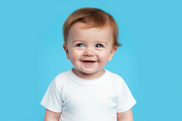 Naklejka premium Baby on Blue Background. Happy Babyboy. Portrait of a Little Child. Toddler is Smiling in White T-shirt. 