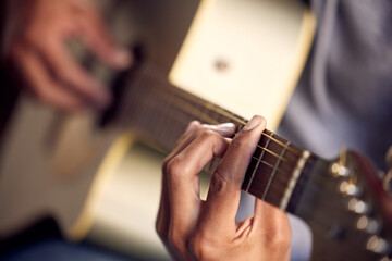 Playing guitar, music and hands of a man on an instrument, learning and strumming for entertainment. Jazz, talent and closeup of a male musician with acoustic music, practicing and instrumental hobby