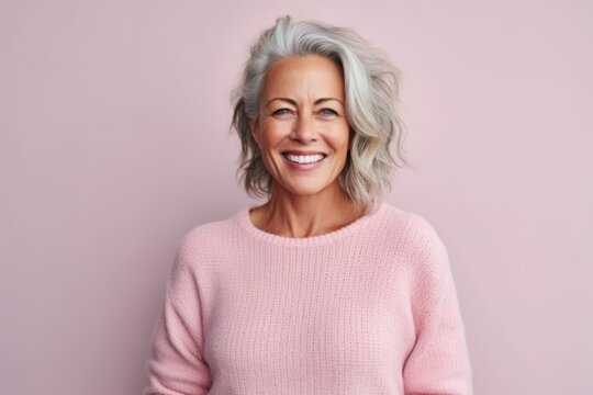 Medium shot portrait photography of a pleased woman in her 50s that is wearing a cozy sweater against a pastel or soft colors background . Generative AI