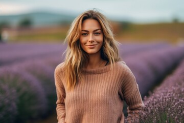 Portrait of beautiful young woman in lavender field. Beautiful girl in a lavender field.