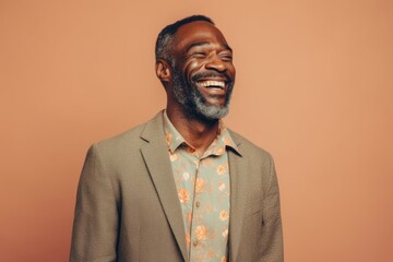 Obraz premium Happy african american man laughing and looking up on orange background
