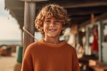 Medium shot portrait photography of a grinning child male that is wearing a cozy sweater against a surf shop or beach activity background . Generative AI