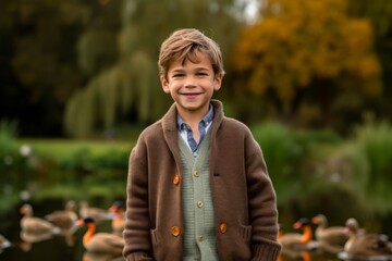 Portrait of a boy in a park with ducks on the background