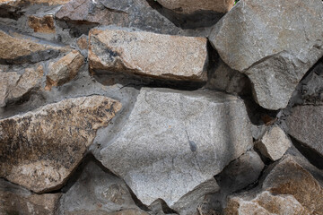 Background of stone wall texture. Macro photo of grey stone wall.