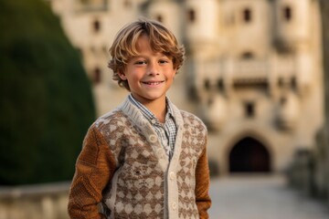 Portrait of a cute boy with blond hair in an old castle