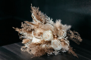 Wedding bouquet of the bride, boho style, outdoor, dry flowers and grass