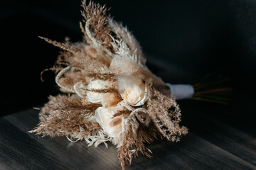 Wedding bouquet of the bride, boho style, outdoor, dry flowers and grass