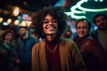Obraz premium Portrait of smiling african american woman with friends in background