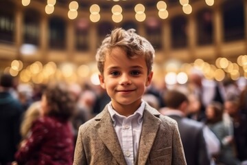 Obraz premium Portrait of a little boy in a business suit on the background of the crowd.