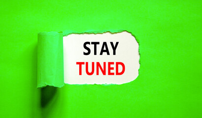 Stay tuned symbol. Concept words Stay tuned on beautiful white paper on a beautiful green background. Business, support, motivation, psychological and stay tuned concept. Copy space.