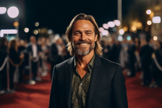 Medium shot portrait photography of a grinning man in his 40s that is wearing a chic cardigan against a hollywood red carpet premiere with stars and cameras background . Generative AI