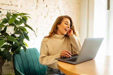 Young woman with laptop at home. Freelance, online course, remote work and lifestyle concept. Online shopping with laptop