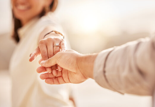 Couple holding hands, engagement and ring, wedding proposal with love and commitment outdoor. Care, trust and relationship with people outside and marriage, life partner and closeup of jewelry