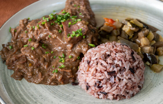 Gardiane de Taureau, gardianne, or daube camarguaise bull slow cooked stew served with rice from Camargue with vegetables, tastes of Camargue, Provence, France