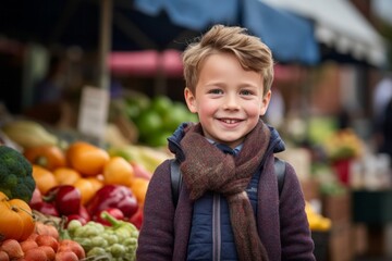 Portrait of a cute little boy at the market in autumn day