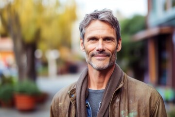 Fototapeta premium Portrait of handsome mature man with grey hair in casual clothes outdoors