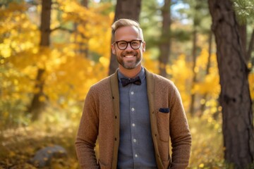Obraz premium Portrait of a handsome young man with glasses in the autumn forest