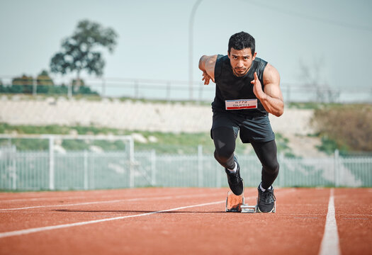 Stadium focus, man running and athlete on a runner and arena track for sprint race training. Fast, run and sports exercise of a male person in marathon for fitness and cardio workout outdoor