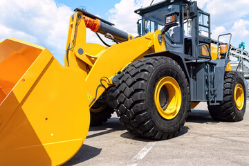 Powerful yellow new front loader. - Powered by Adobe