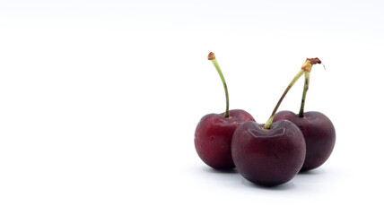 close up of a group of beautiful red cherries on a white background