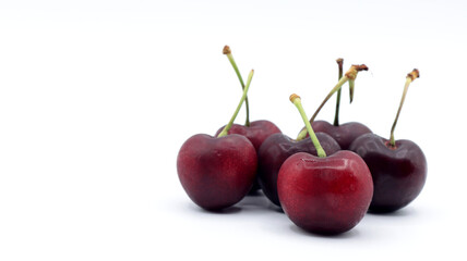 close up of a group of beautiful red cherries on a white background