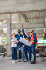 happy family visiting and talking to contractor at site,engineer or architect explain progress of a house building with construction paper to young couple,concept of business,real estate home project