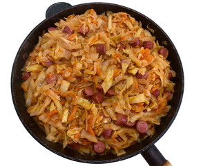 White cabbage stew with smoked pork sausages and tomato paste in a frying pan isolated on white