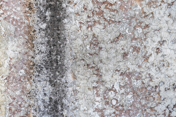 Old grungy concrete wall with old paint and lime as a background or texture