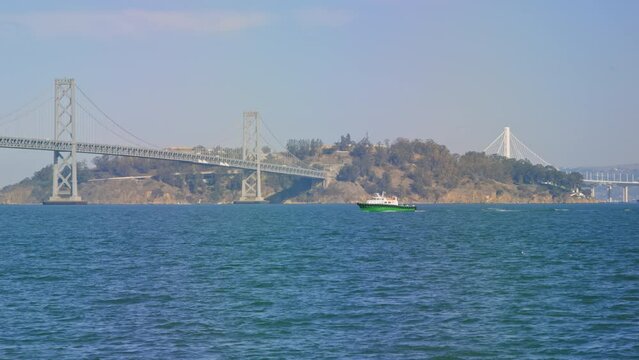 Ferry boat passes in front of Bay Bridge and Treasure Island, San Francisco Bay