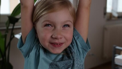 Sleepy child girl with snot yawns raising hands up