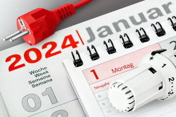 Konzept für Energie und Deutscher Kalender Datum 1. Januar 2024 Heizungsthermostat und rotes...