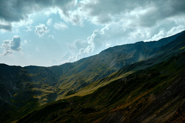 Mountain ranges on a sunny day at Georgia. Sky with clouds adn hills