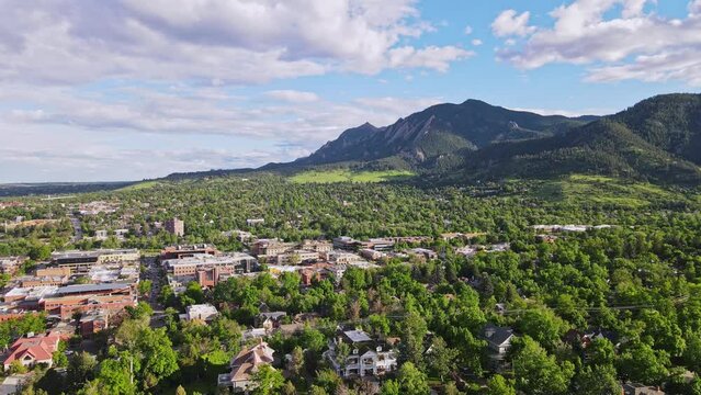 Beautiful flatirons can be seen in a distant and green trees of Boulder Colorado