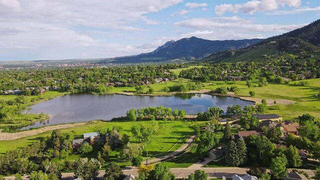 In this captivating drone shot, the camera smoothly glides in a parallel motion, capturing the enchanting 360-degree view of Wonderland Lake in Boulder, Colorado